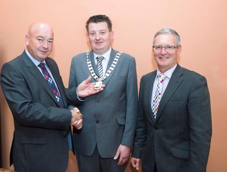 Cllr. Kevin O’Keeffe handing over the Chain of Office to newly elected Cathaoirleach, Cllr. Damien Geoghegan after the AGM in Assembly House on Friday 10th July